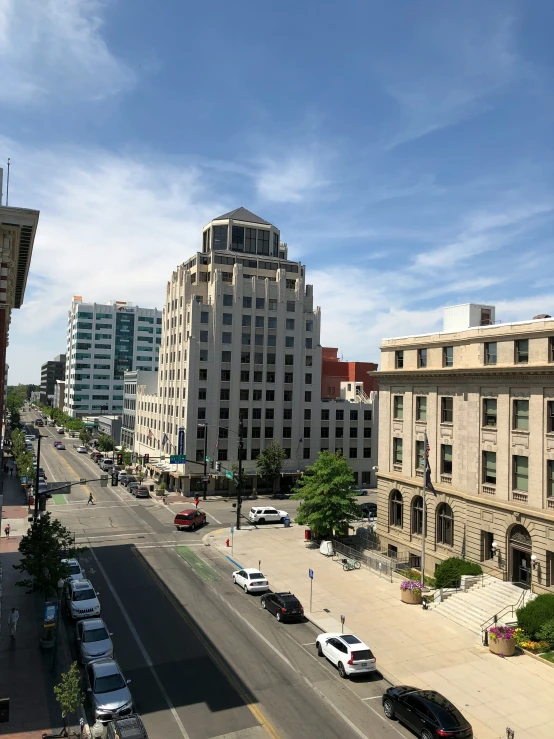 cars parked on the street in front of large buildings