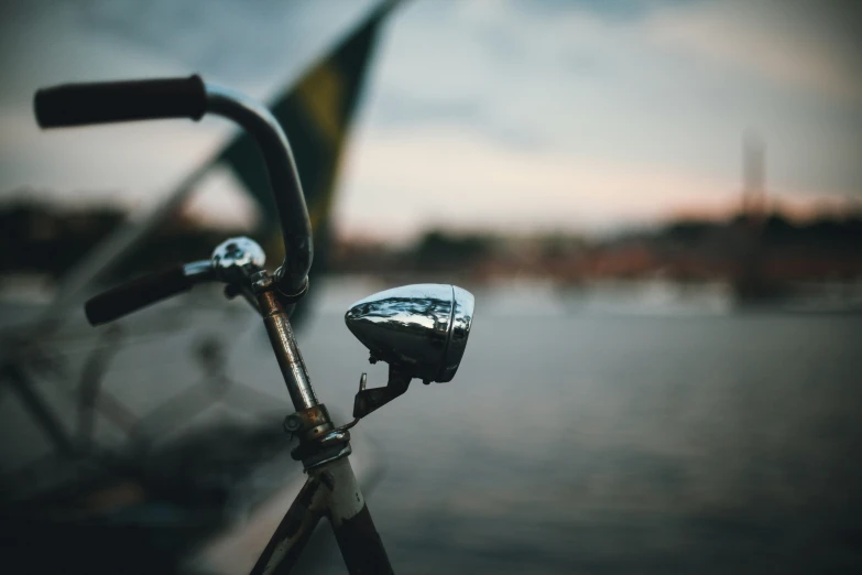 a bike with a handlebar and some water and sky in the background