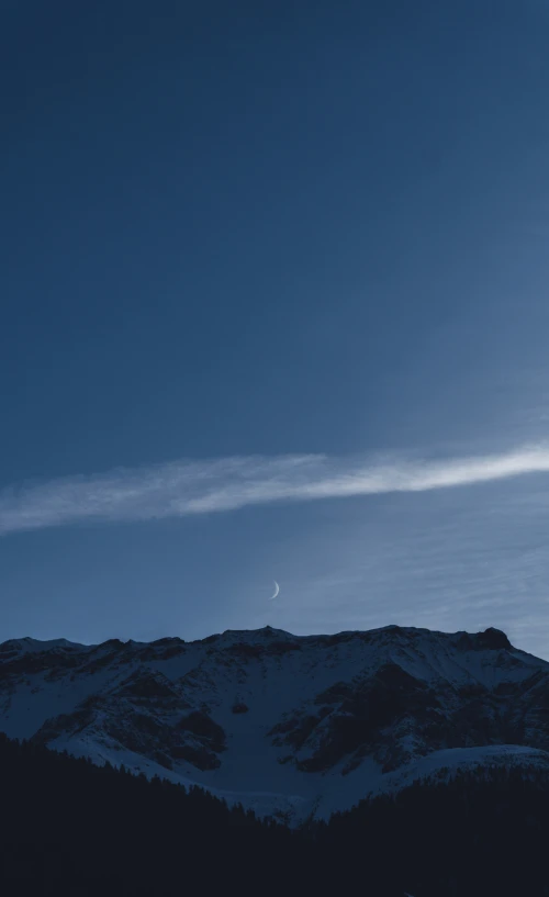 a person walking on top of a snowy hill