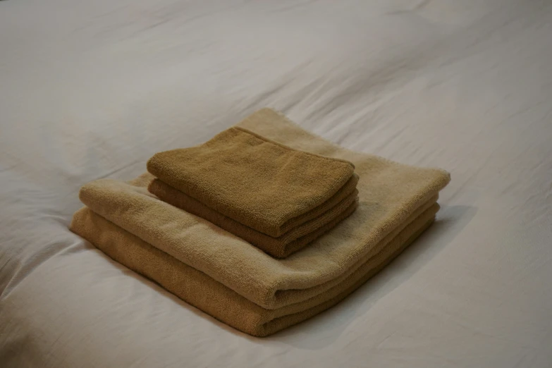 a towel is folded on top of a bed