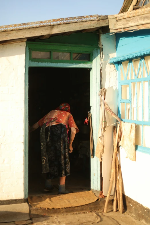 an african woman is walking out of the door