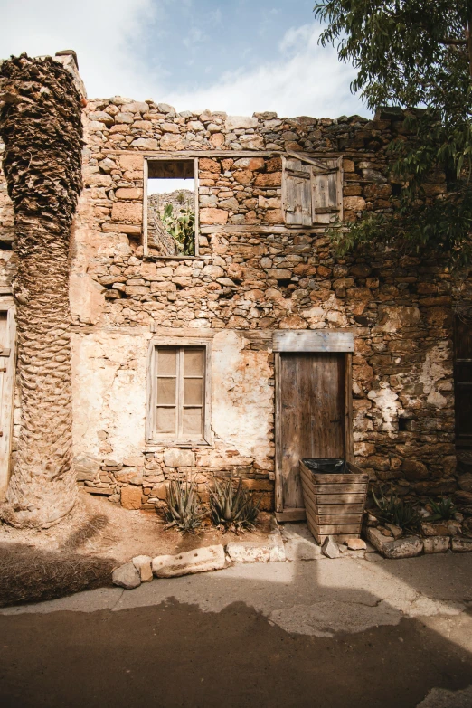 an old building with the window and door open