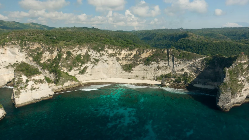 a beach with cliffs and water underneath