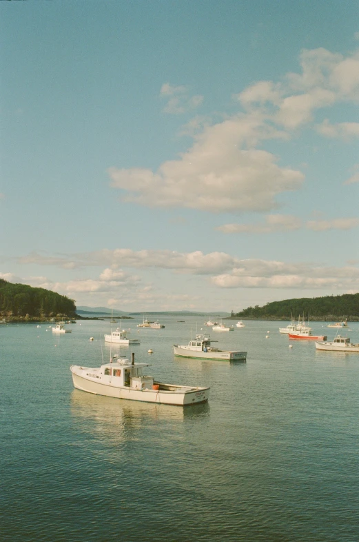 several boats are sitting in the ocean during the day