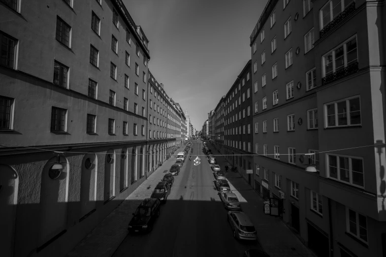 black and white pograph of city street from the rooftop