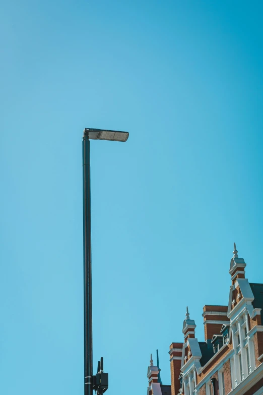 the traffic light has a sign on it near buildings