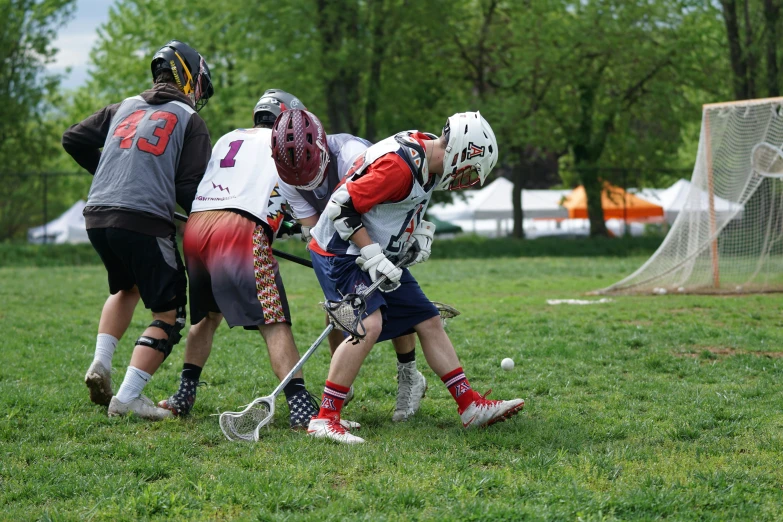 boys playing field hockey against each other on the field