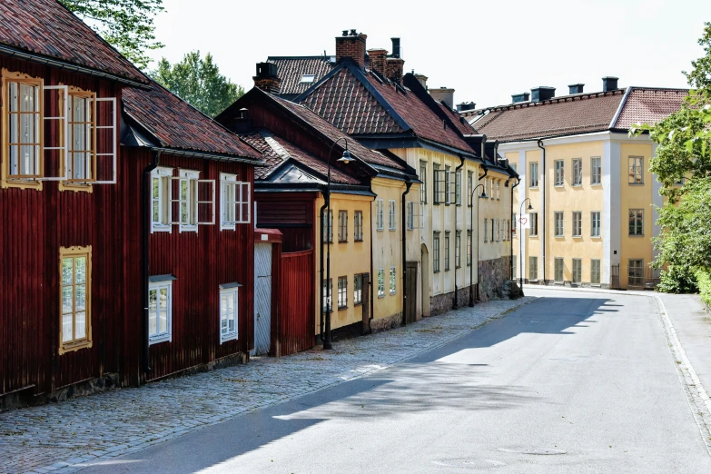 a street with several old wooden buildings in the back