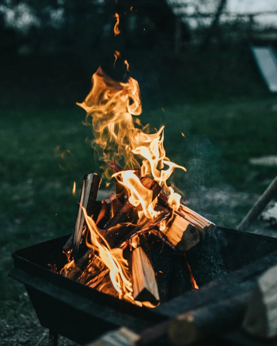 flames blazing inside of an old fashioned grill