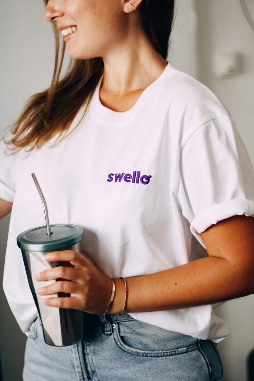 a girl holding a cup with the words hello on it