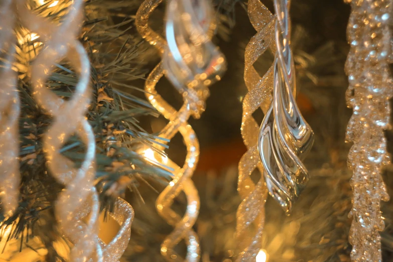 several ornaments in front of a lighted christmas tree