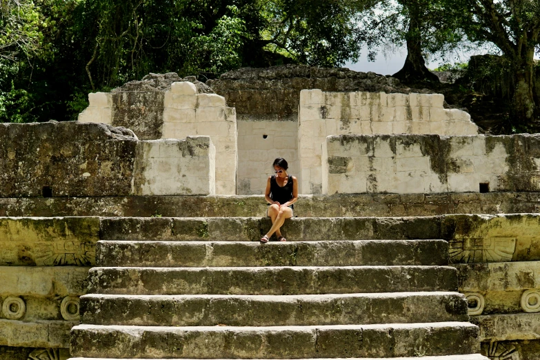 a woman sitting on a set of steps next to a doorway