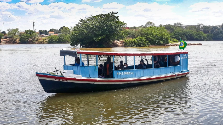 a red and blue boat in the middle of water