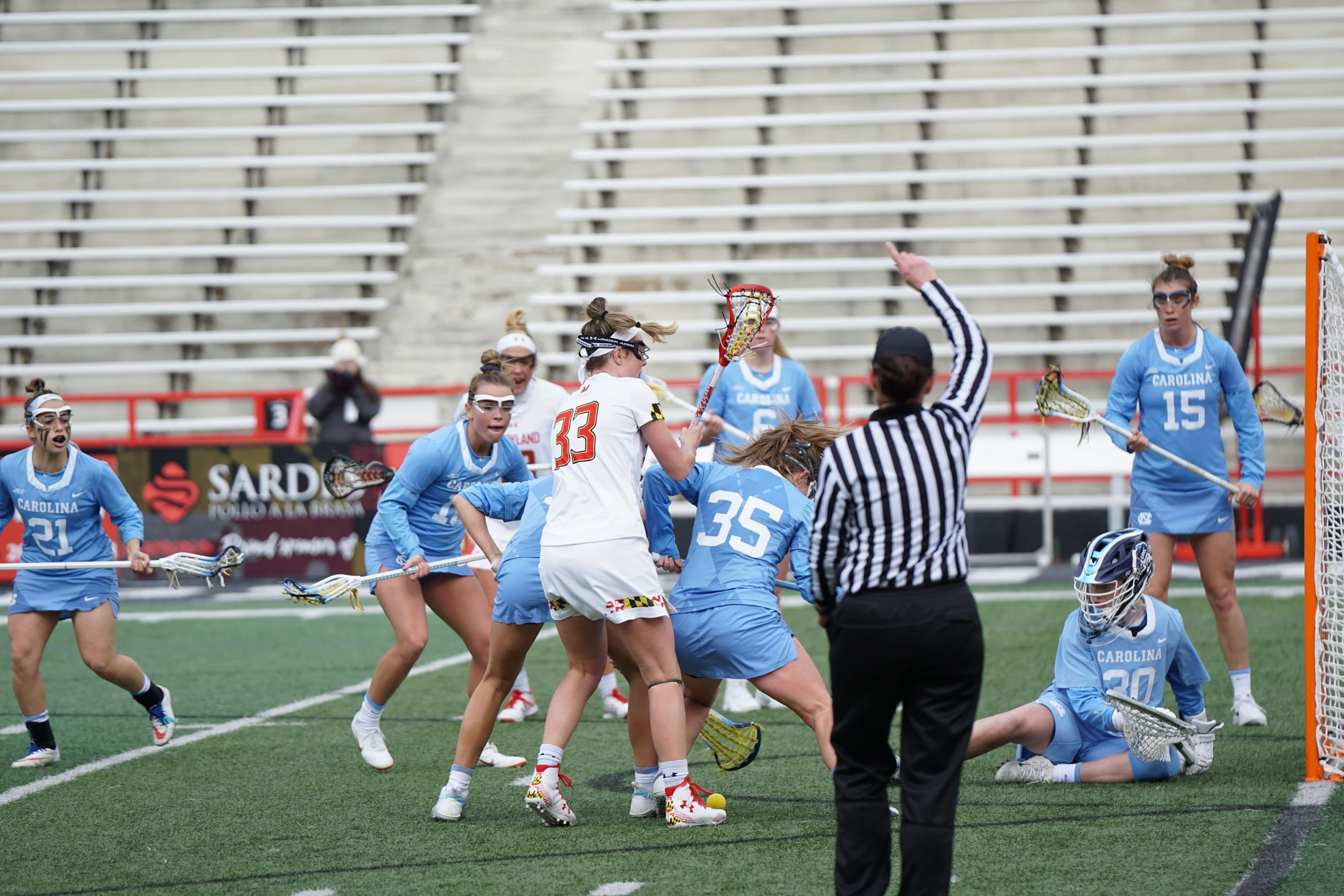 two teams of women compete in the game of lacrosse