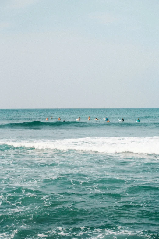 many people are on their surf boards in the water