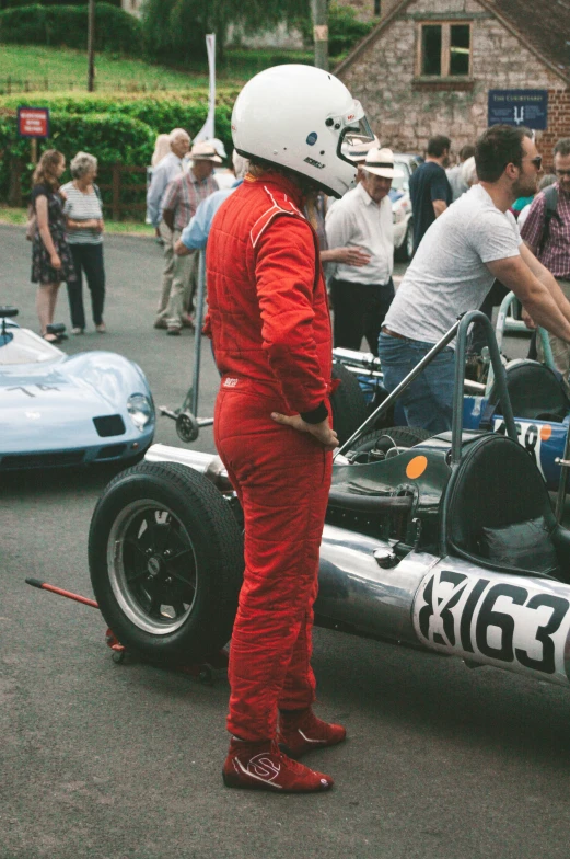 a person in a racing car next to others