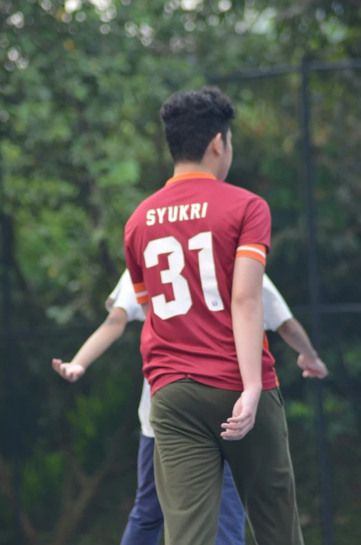 two people are playing frisbee in the park