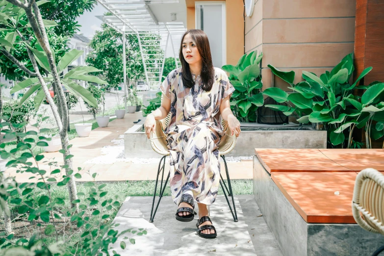 a woman is sitting on a chair and looks back over her shoulder