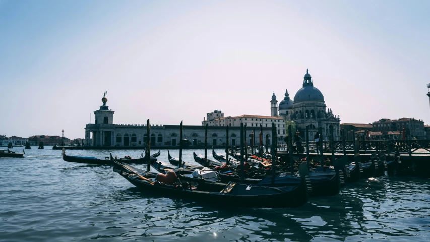 several boats tied up along the shore in venice