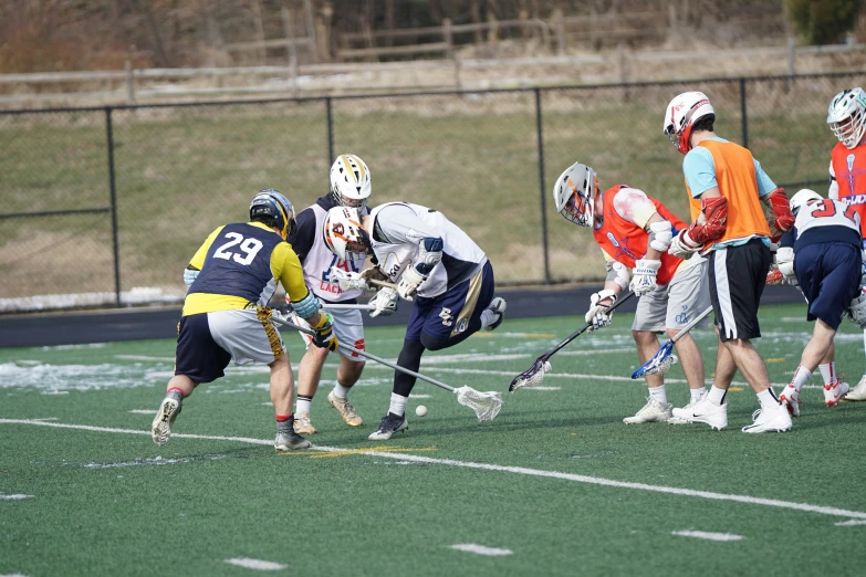 a group of s playing field hockey on a field