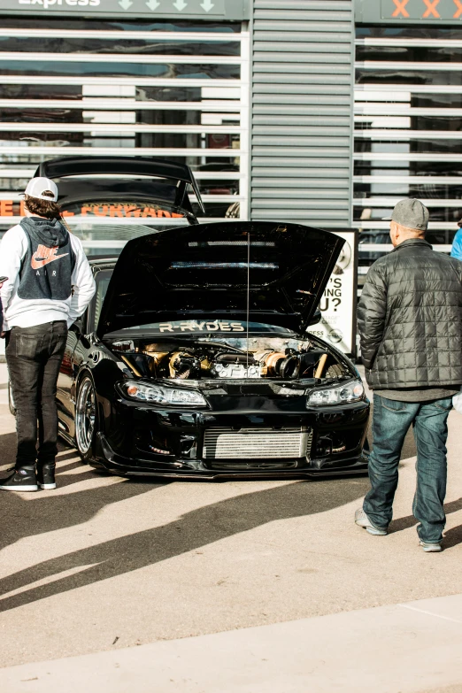 a couple of people next to a car