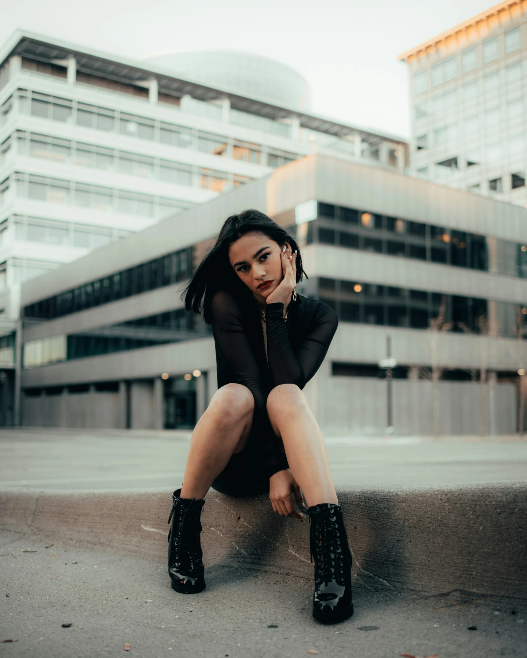 the woman is posing in front of a building