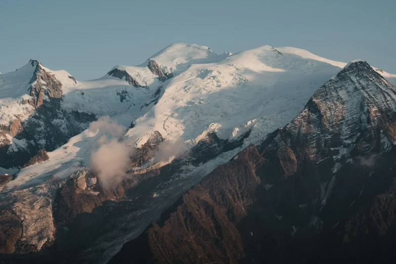 a view of a mountain and a cloud in the air