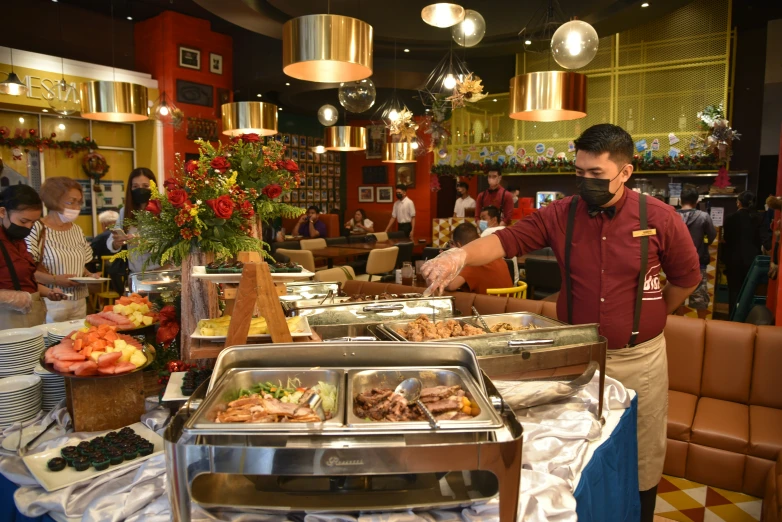 a buffet area filled with lots of trays of food