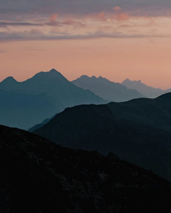 a mountain range with mountains under a sky line