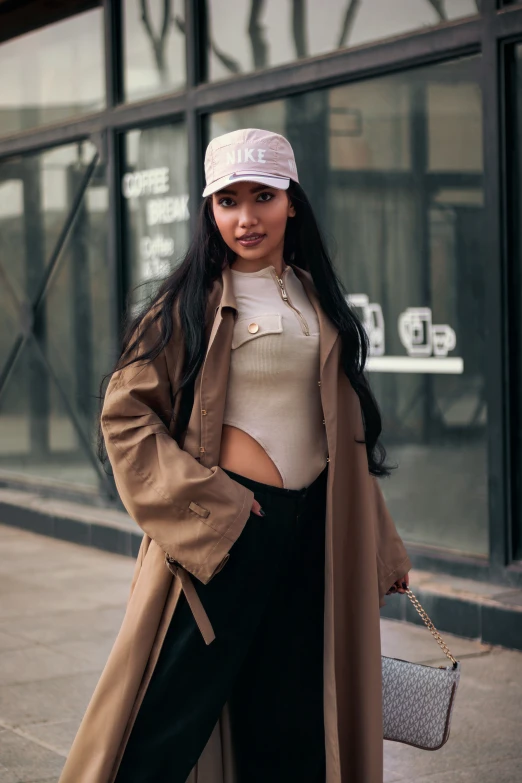 a woman in black pants and jacket posing on the street