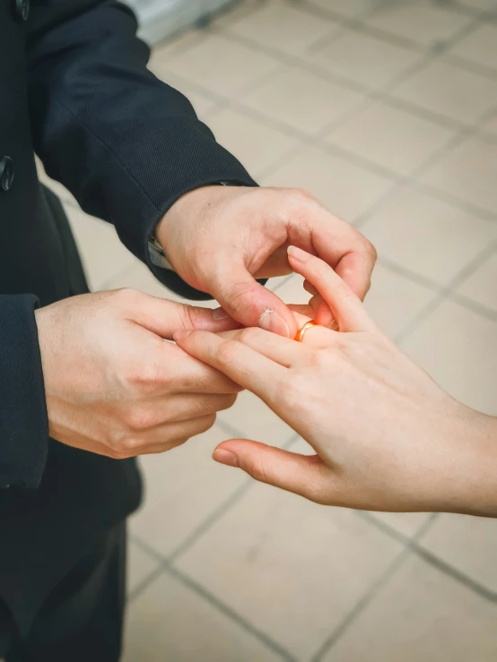 two people who are putting soing in each others hand