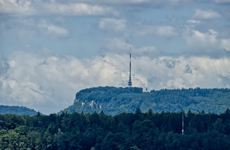 an unusual tower is sitting atop a mountain range