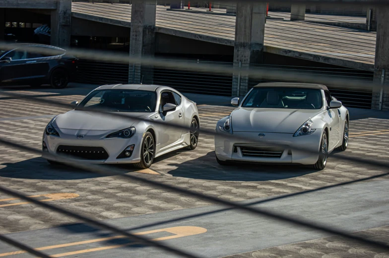 two very sleek looking cars parked side by side