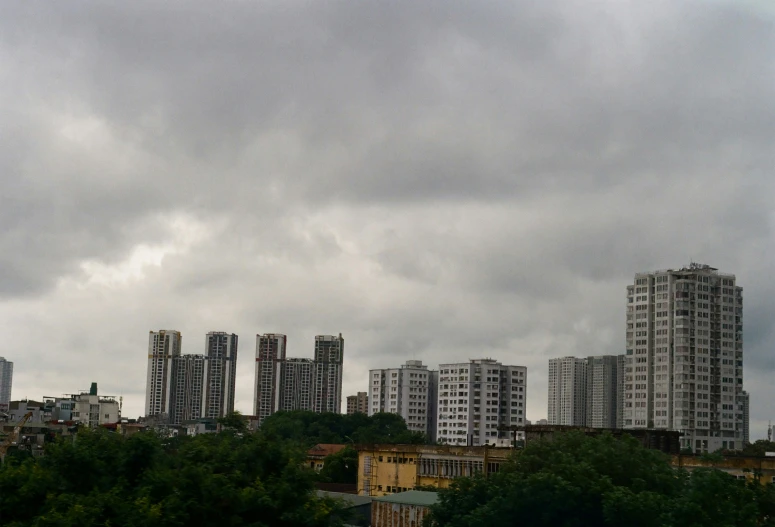 high rise apartment buildings under a cloudy sky