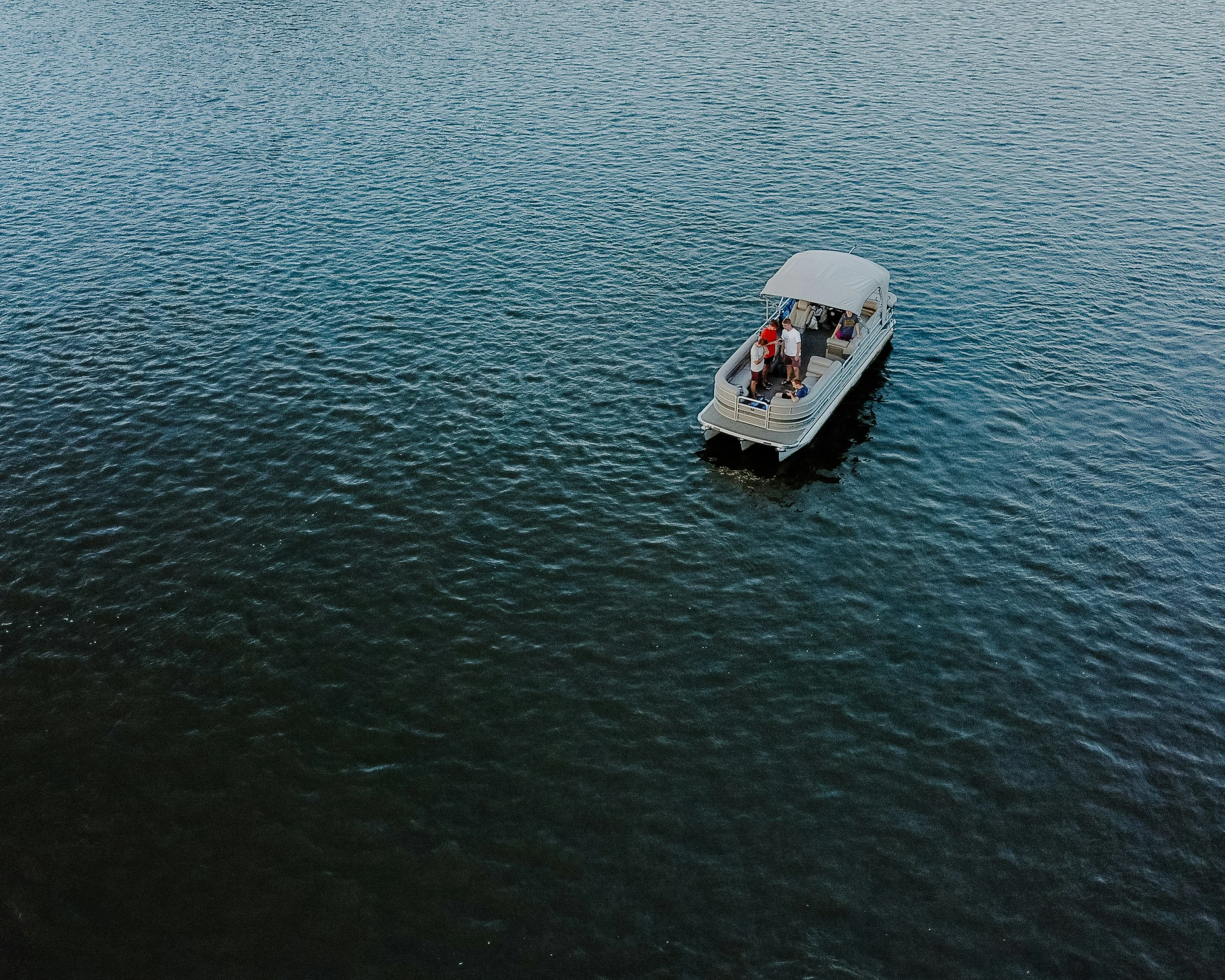 a white boat traveling across a body of water