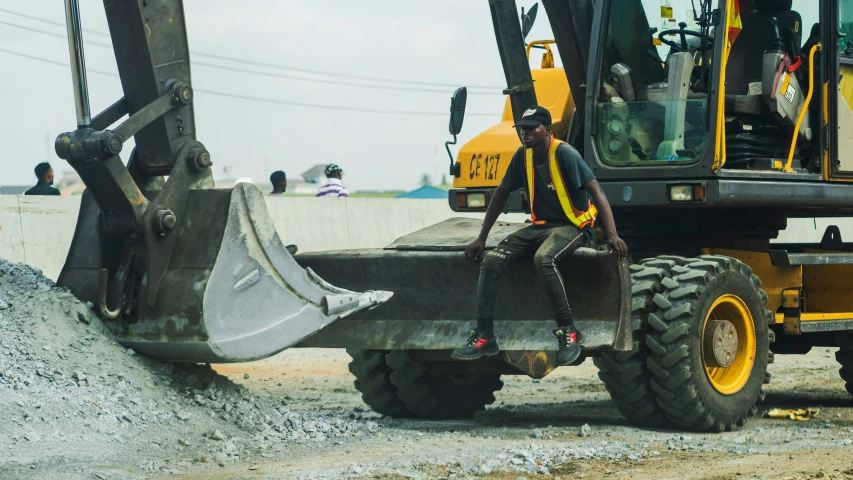 an image of a worker digging dirt on the road