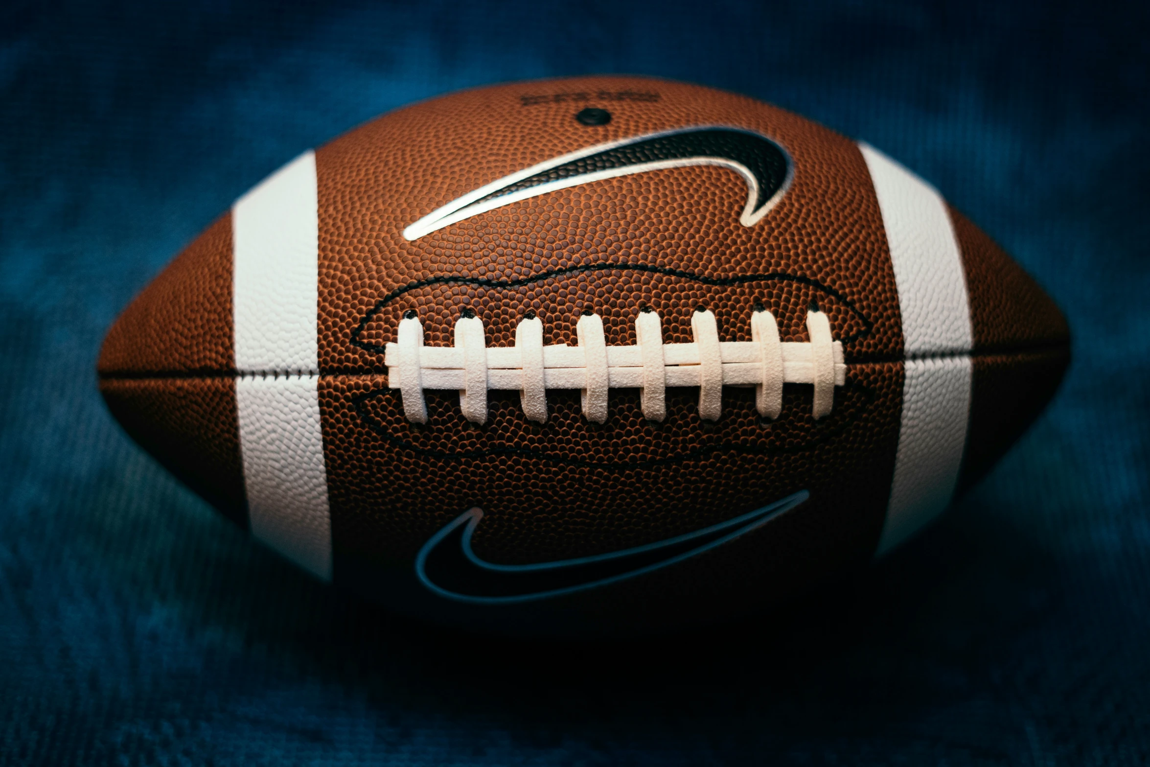 an image of a football sitting on the ground