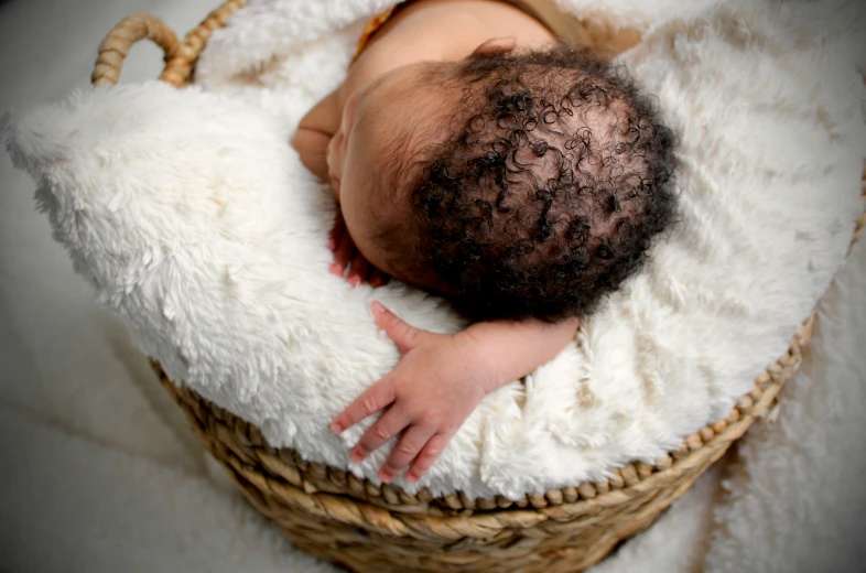 a baby that is laying down in a basket