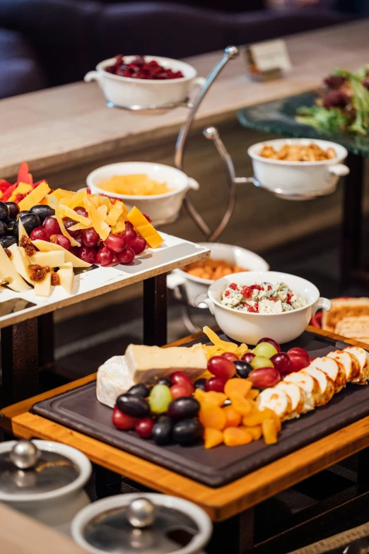 three plates with different kinds of cheese and fruit