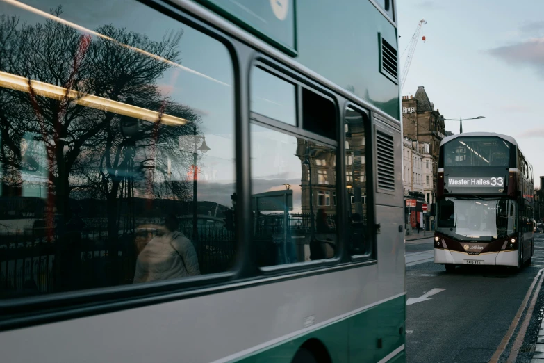 a double decker bus drives down the street