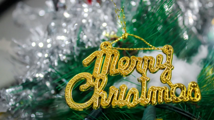 a decorative ornament hanging from the side of a christmas tree