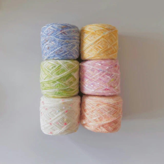 the different colored spools of yarn are lined up