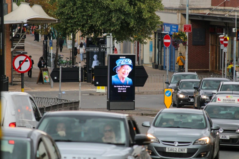 car traffic and a large advertit with a man on it