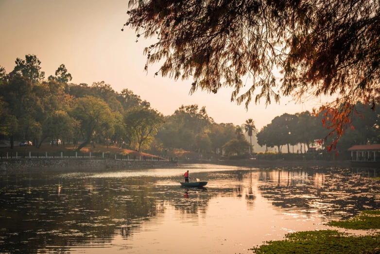 a boat is on a river near a lake with trees