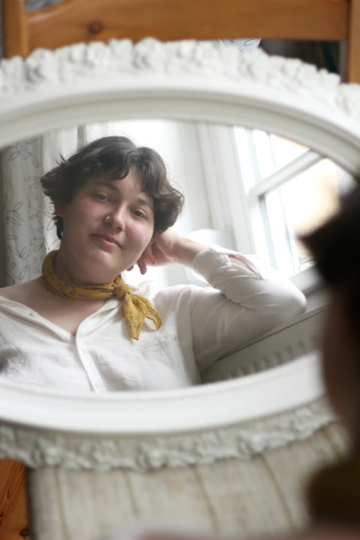 woman in front of mirror with arm raised