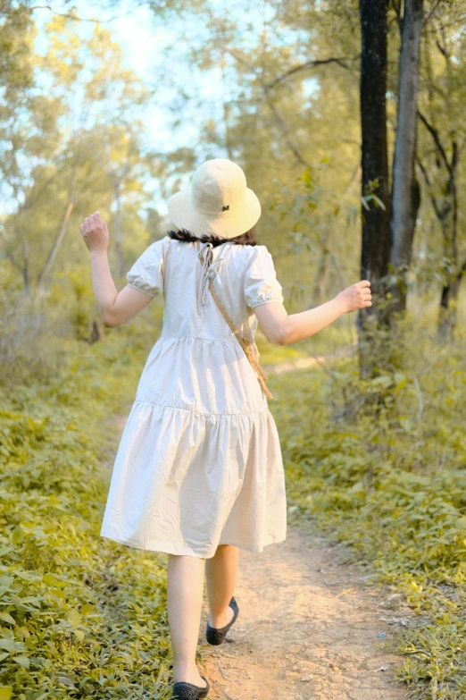 a  is walking in the woods carrying an umbrella