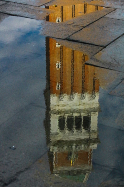 a building is in the water near a curb