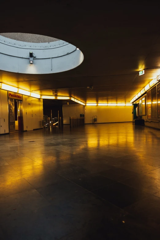 an empty public room with large circular mirror