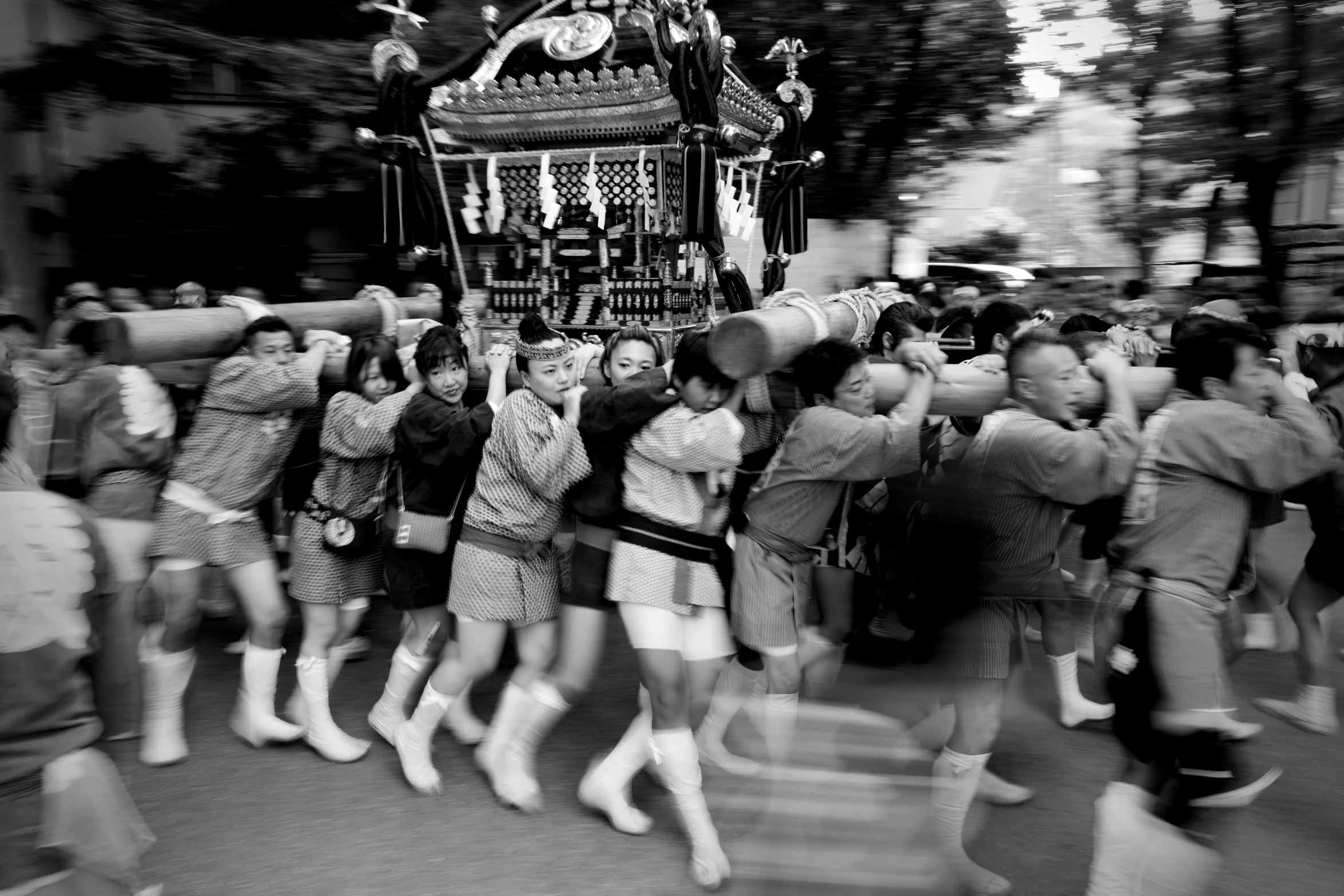 a very large group of people with a procession going by