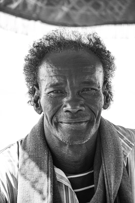 an african american man smiling with his eyes closed